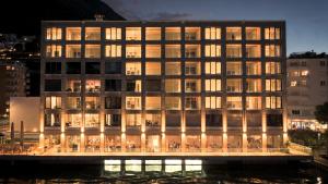 a building with lights on in a city at night at Residenza Du Lac in Paradiso