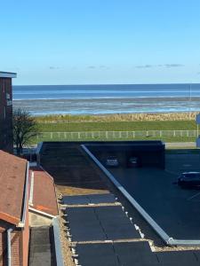 a parking lot with the ocean in the background at Stranddüne in Cuxhaven