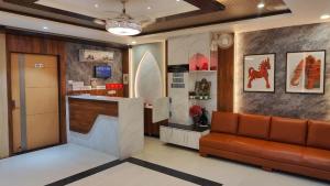 a lobby with a waiting room with a couch at Hotel Sapphire Inn in Gorakhpur