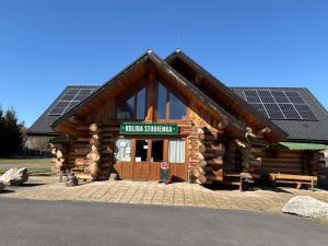 a log cabin with solar panels on the roof at Koliba Studienka in Kokava na Rimavica