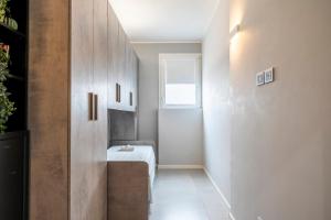 a small bathroom with a bench and a window at NEW - 2 Min Metro Batoni - Luxury Apt con Posto Auto in Florence