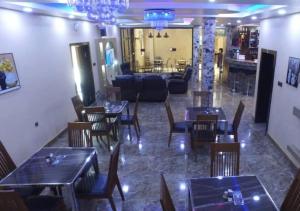a restaurant with tables and chairs in a room at Grand Diamond Hotels & Suites LTD in Owerri