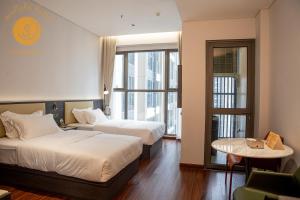 Ένα ή περισσότερα κρεβάτια σε δωμάτιο στο Sunlight Condotel Hanoi