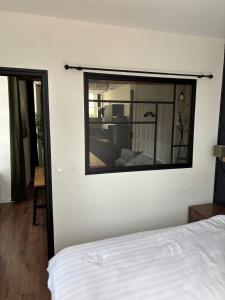 a bedroom with a mirror on the wall at Appartement plein coeur de ville in Fontenay-le-Comte