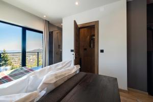 una camera da letto con un letto e una grande finestra di NOOK Kopaonik Luxury Apart & House a Kopaonik
