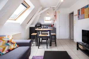 a living room with a couch and a table at immeuble entier ✰ coeur de ville ✰ terrasse balcon in Segré