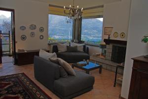a living room with a couch and a fireplace at Villa Grazie Mille - Charming Lake Como Escape in Perledo +38 photos