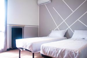 Postel nebo postele na pokoji v ubytování Camere della Perla