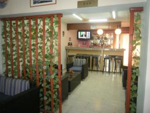 a waiting room with a bar in a restaurant at Tassos Apartments in Faliraki