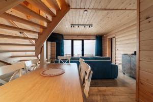 a living room with a wooden table and a blue couch at Brdy Koniakowskie in Koniaków