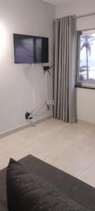 a living room with a flat screen tv on the wall at Unwind and Relax in Amanzimtoti