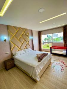 a bedroom with a large bed and a large window at Marchica bay 5 holiday apartments in Nador