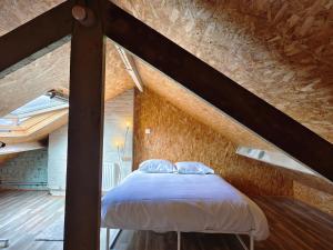a bedroom with a bed in a attic at Amazing house 4 bedrooms parking close to Lille in Saint-André-lez-Lille