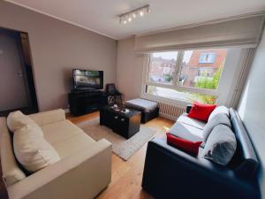 a living room with a couch and a television at Amazing house 4 bedrooms parking close to Lille in Saint-André-lez-Lille