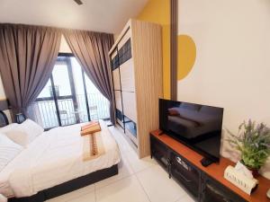 a bedroom with a bed and a flat screen tv at Quiet Scenic High Floor Parkview at Skytrees, 1-3 pax in Johor Bahru