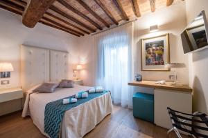 Postel nebo postele na pokoji v ubytování Hotel Il Palazzo