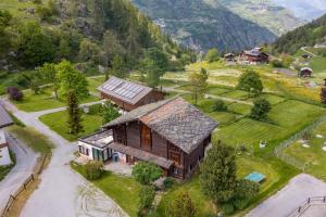 an aerial view of a house in the mountains at Gästehaus auf Camping Grächbiel in Grächen