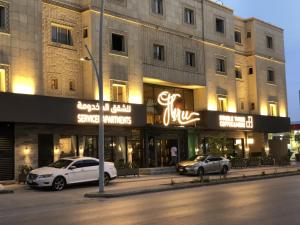 two cars parked in front of a building at شقق ثري ستار للشقق المخدومة 4 in Riyadh