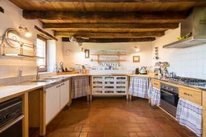 a large kitchen with wooden floors and wooden ceilings at La Casa de la Llum in Amer