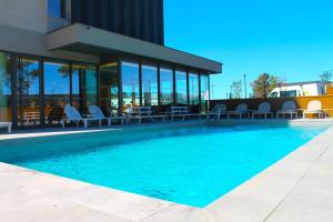 a swimming pool in front of a building at Adonis le Castellet in Signes