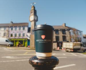 a cup of coffee sitting on top of a pole at 1997 Stays Westport in Westport +10 photos