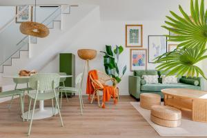 a living room with a couch and tables and chairs at way2sun penthouses Gran Alacant - FREE e-bikes & jacuzzi & solarium & PS5 in Gran Alacant
