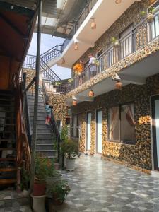 a building with stairs and people standing on the balcony at Mai Châu Homestay 88 in Mai Chau