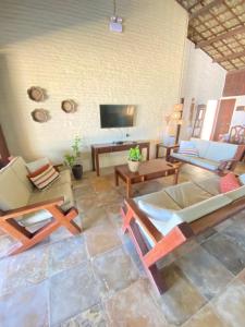 a living room filled with furniture and a flat screen tv at Condado da Praia ,casa em Flecheiras 7 a 10 suítes in Flecheiras