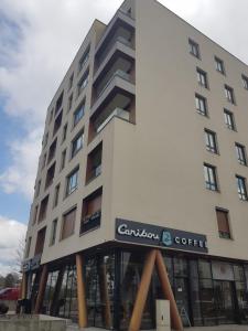 a large white building with a sign on it at ILiDZA SKY in Sarajevo