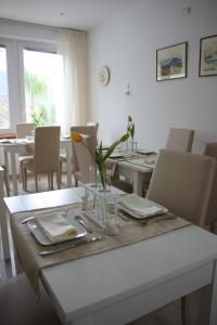a dining room with a table and chairs with flowers on it at Villa Loreta in Forio d'Ischia