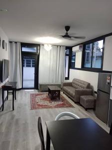 a living room with a couch and a table at Homestay Daud in Bandar Permas