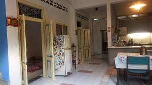 a kitchen with yellow doors and a refrigerator at Kranggan Bethlehem Homestay in Yogyakarta