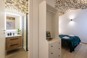 a small bedroom with a bed and a sink at Torre delle Rondini in Isolabona