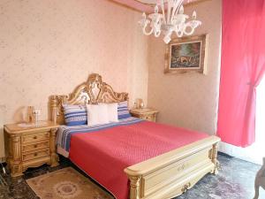 a bedroom with a bed with a red bedspread and two night stands at VILLA FELICE in Loano +92 photos