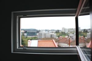 a view of a city from a window at Apartamentos do Parque in Vila Real