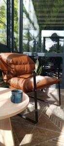 a brown leather couch sitting on top of a table at Port Hotel, Tasucu in Silifke