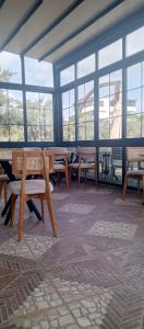a room with tables and chairs and windows at Port Hotel, Tasucu in Silifke