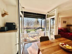 a dining room with a table and a sliding glass door at Kuckucksnest - Ferienwohnung mit Traumblick im Schwarzwald in Bad Wildbad