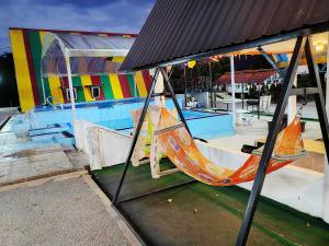 a hammock sitting in front of a building at Chemara Dusuntara Homestay in Jeniang +35 photos