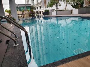 a swimming pool with blue water in a building at Quiet Scenic High Floor Parkview at Skytrees, 1-3 pax in Johor Bahru
