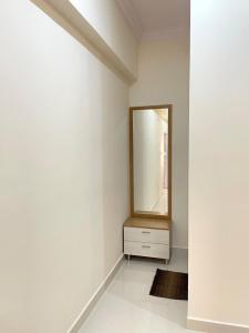 a white room with a mirror and a dresser at Luxury Homes in Hyderabad +1 photo