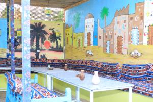 a room with a mural on the wall at Mama Africa Camp in Luxor