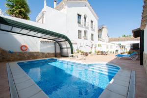 a swimming pool in front of a house at Puerta del Agua in Uclés