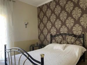 a bedroom with a bed with a patterned wall at SeaViewPeramou in Elevtheraí +17 photos