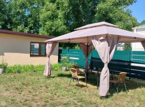 a table and chairs under an umbrella in a yard at Domek letniskowy ,,Jolczyn'' in Nowęcin +6 photos