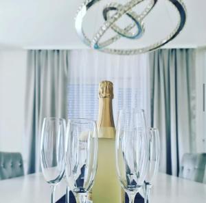 a group of wine glasses sitting on a table with a chandelier at LUXURY VILLA HELENA in Kaštela