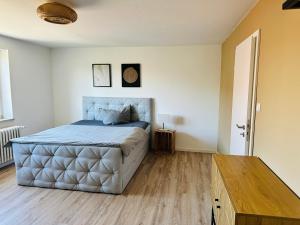 a bedroom with a large bed and a wooden floor at zum Mozart in Volkach