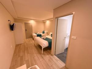 a hotel room with a bed and a mirror at Marco Polo Motor Inn Sydney Hotel in Sydney
