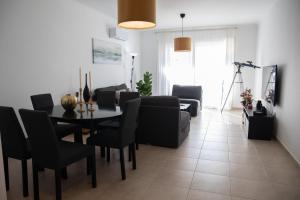 a living room with a table and black chairs at Thalia's Holiday Apartment in Tala Chorio in Tala +29 photos