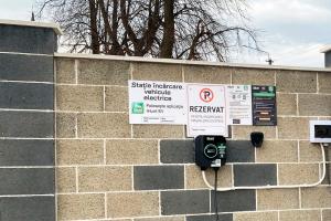 a brick wall with a parking meter and signs on it at Pensiunea Sofy Mar in Poiana Micului